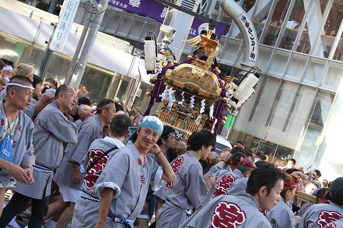 Festival de quartier avec des gens qui portent un sanctuaire portatif dans le quartier de Shibuya à Tokyo